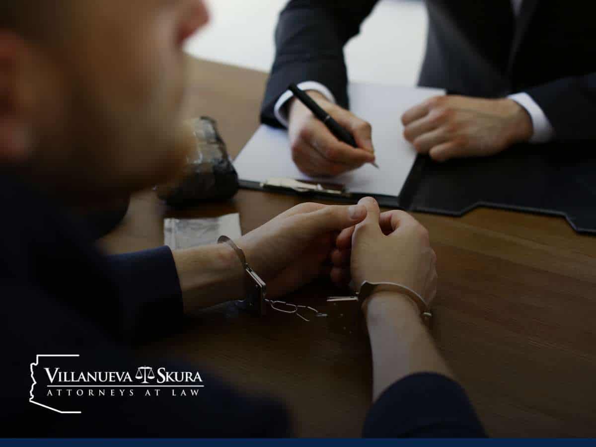 A person in handcuffs consulting with an attorney, representing the assistance of Sex Crime Lawyers.