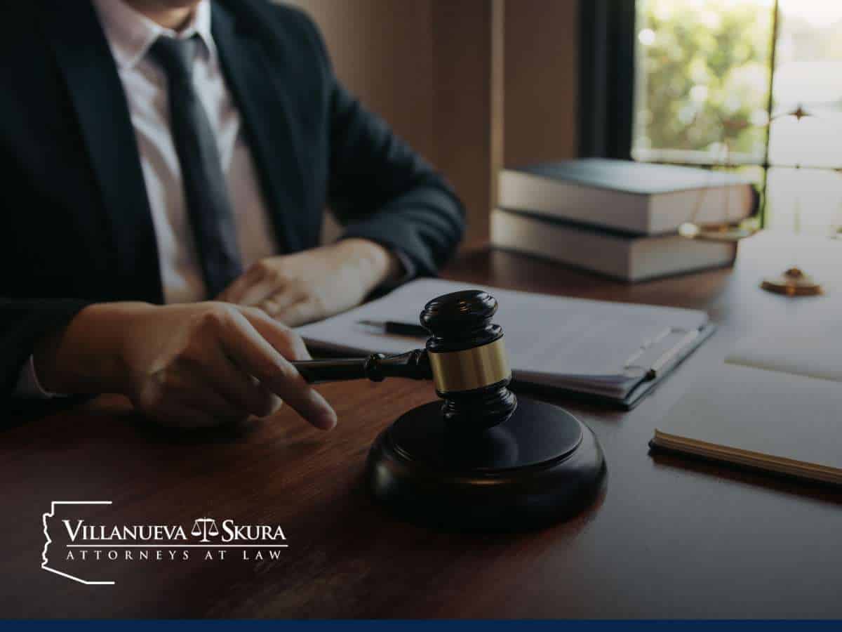 Attorney holding gavel at desk with legal documents, representing sexual assault cases in Arizona